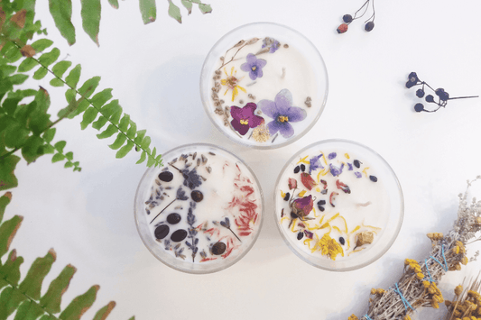 Handmade soy candle with crystals and dried flowers in glass jar